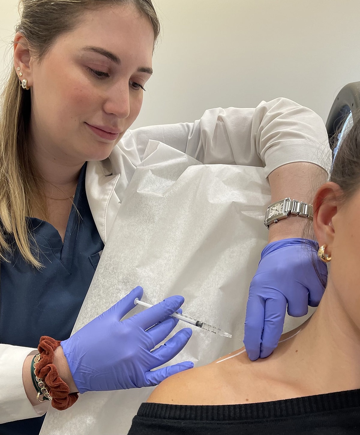 Medical professional preparing patient for procedure.