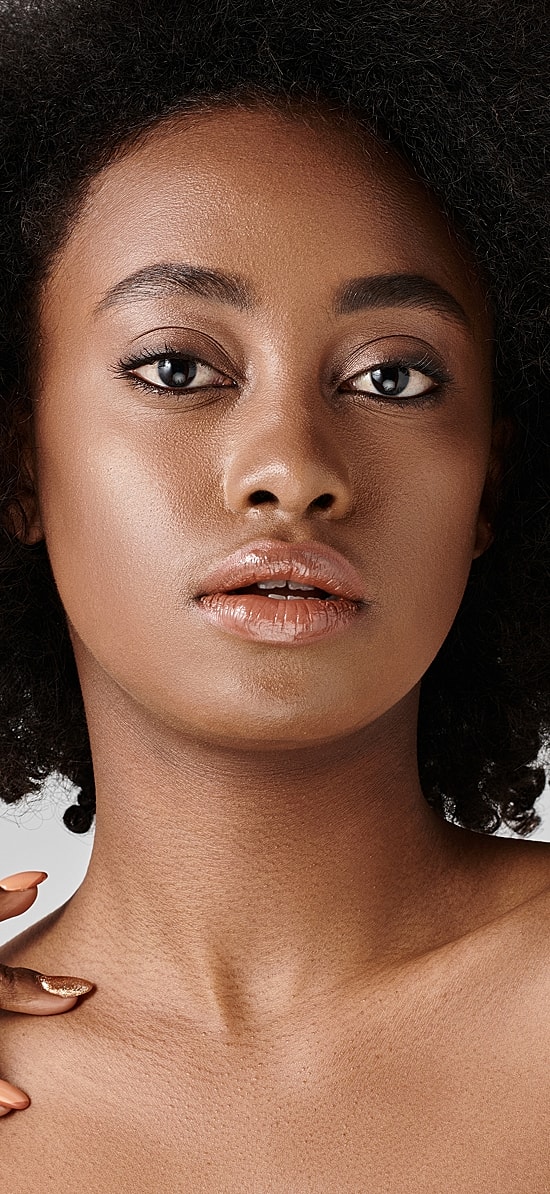 Woman with styled hair and natural makeup.