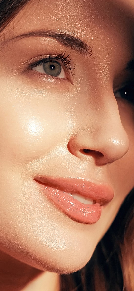Woman with styled hair and natural makeup.