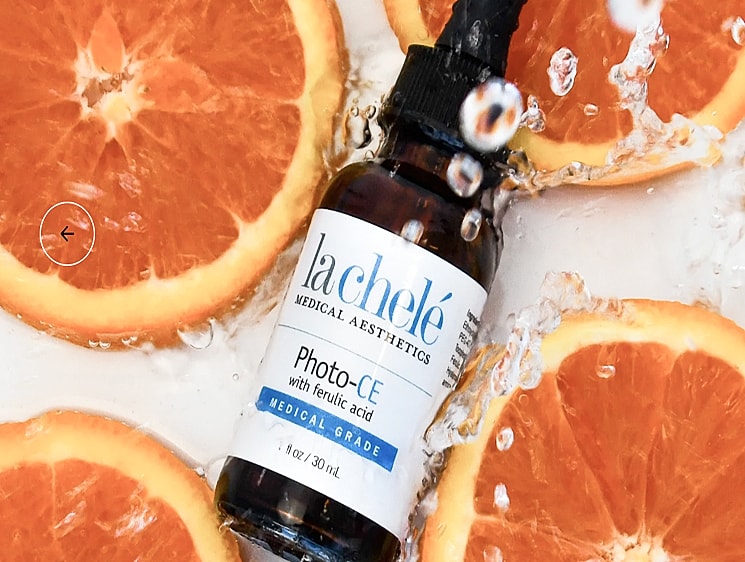 Vitamin serum with oranges and water splashes.