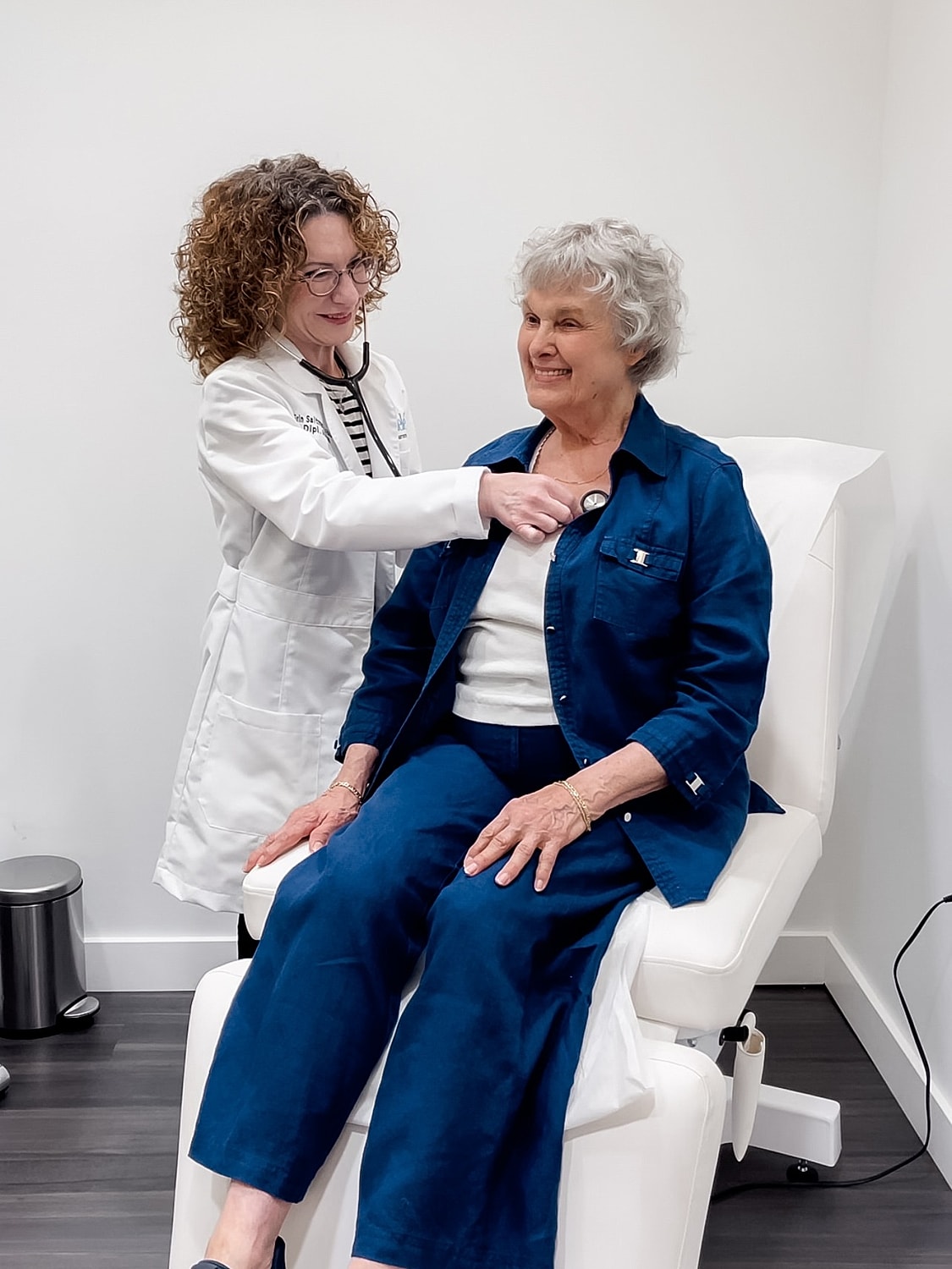 Person adjusting loose-fitting blue jeans.