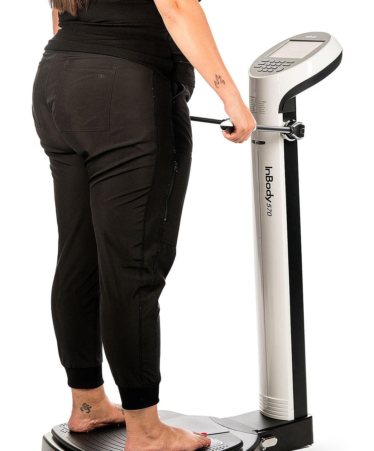 Person using a body composition analyzer machine.