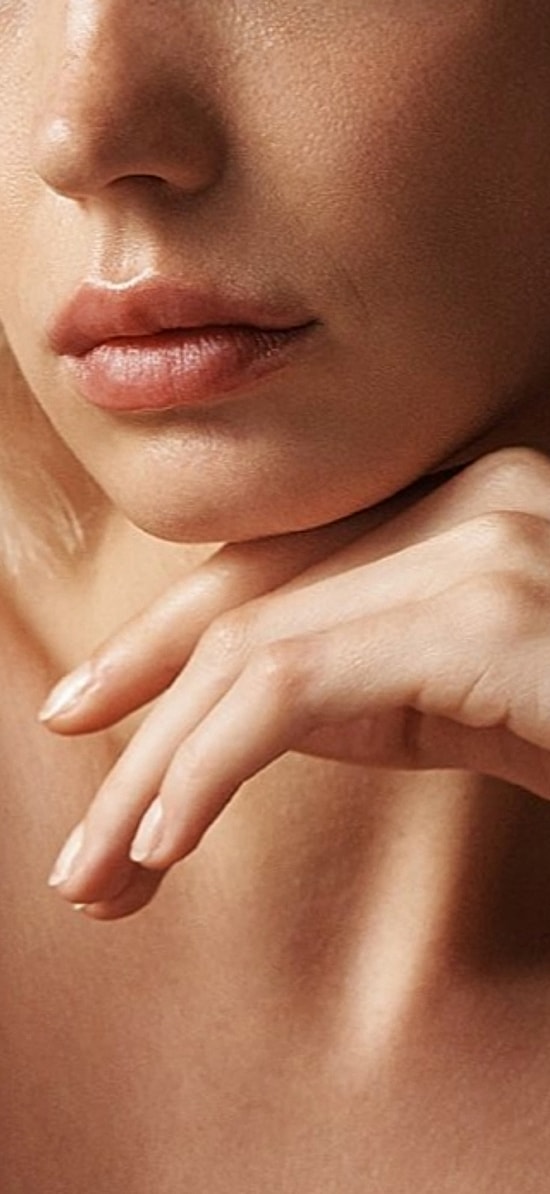 Woman with styled hair and natural makeup.