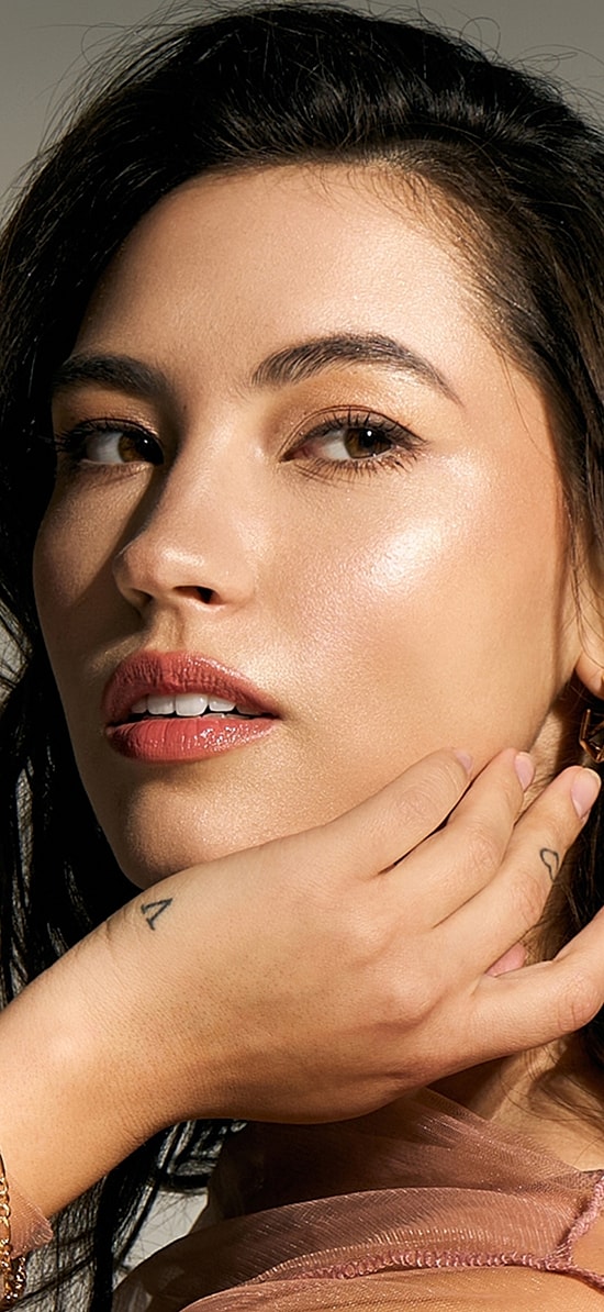 Woman with styled hair and natural makeup.