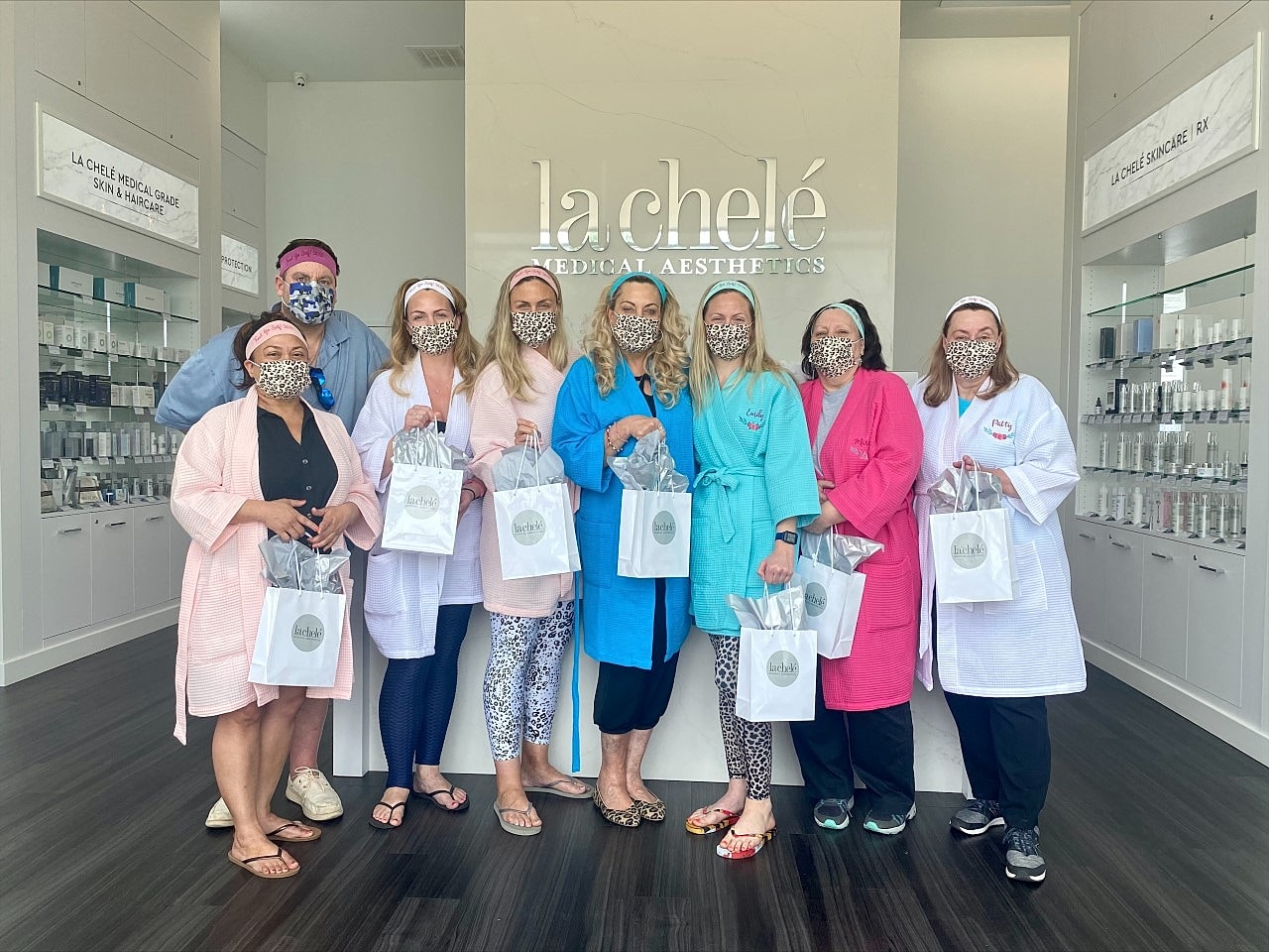 Group of women in robes at aesthetic clinic.