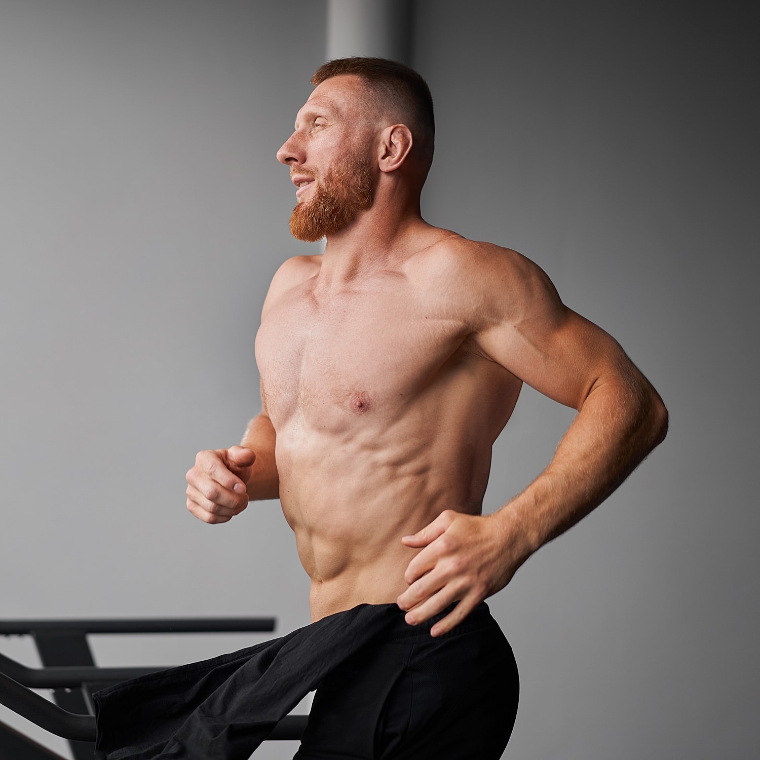Man running on a treadmill, showcasing fitness.