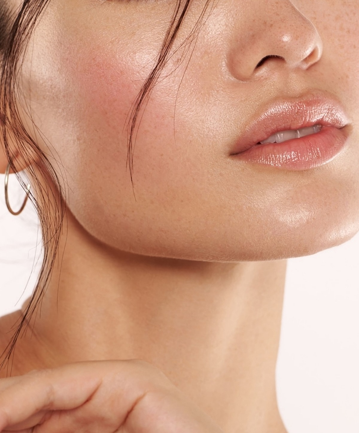 Close-up of glowing skin and soft lips.