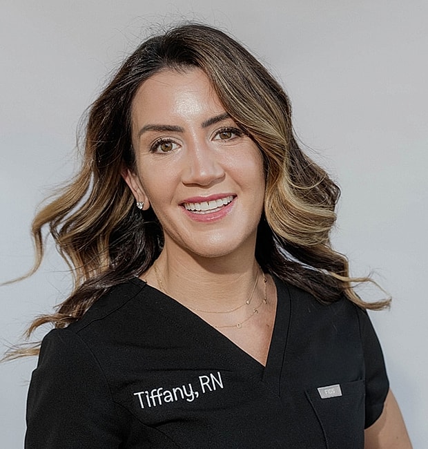 Nurse Tiffany smiling in professional attire.