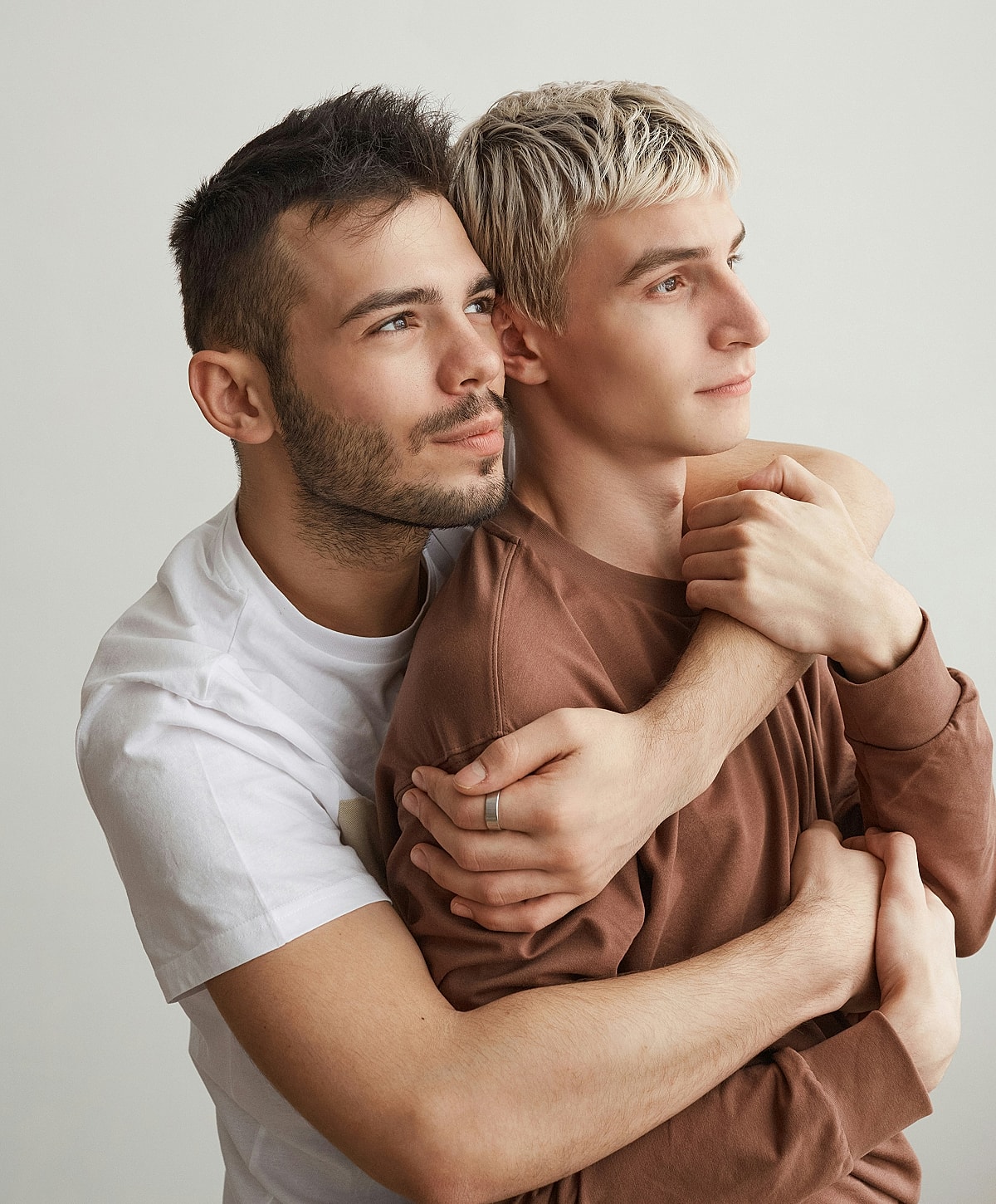 Two men embracing in a warm moment.