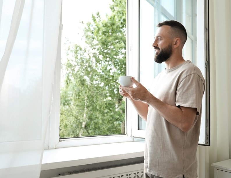 Man enjoying coffee by the window.