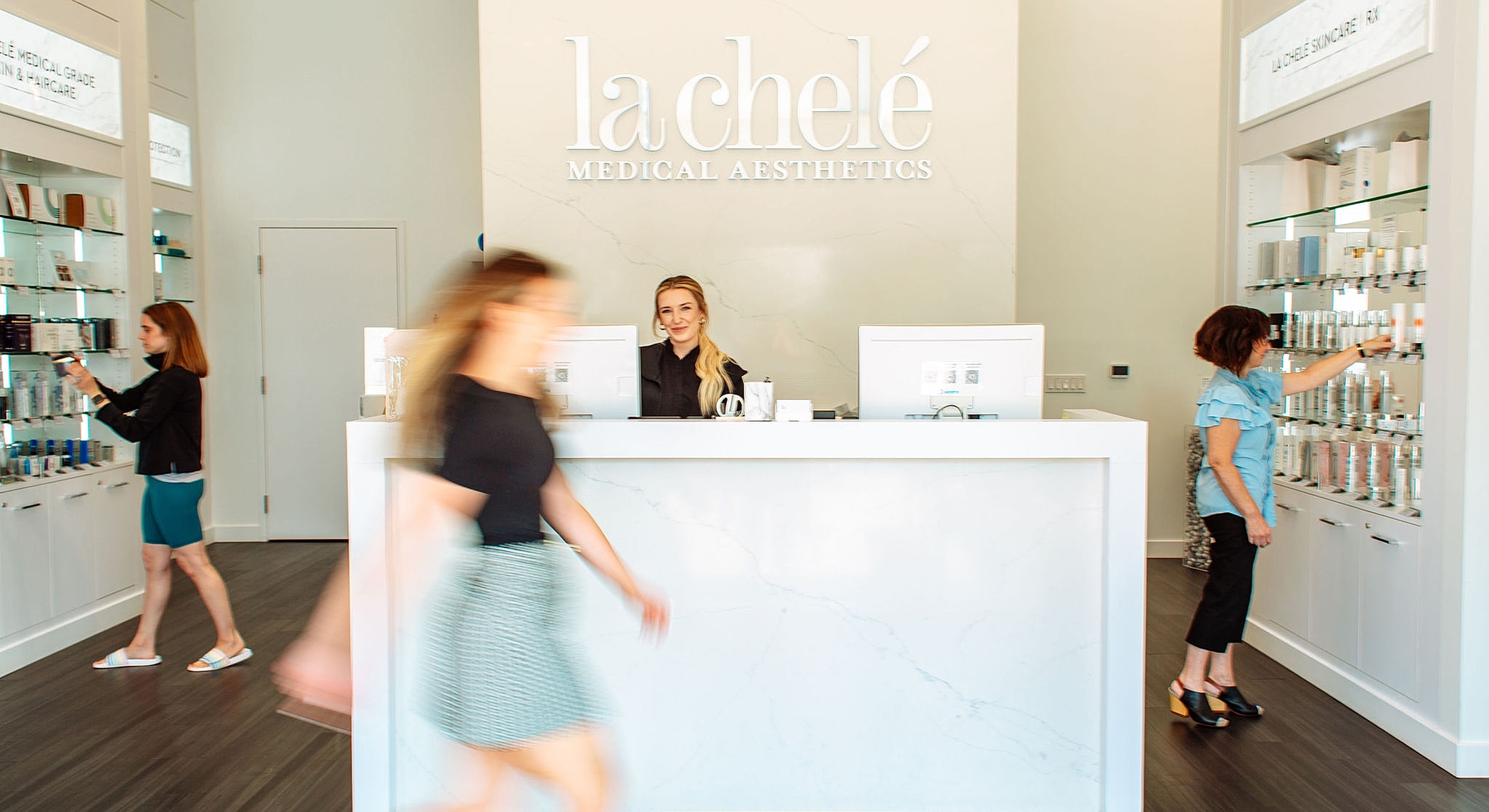 Aesthetics clinic with staff and customers browsing products.