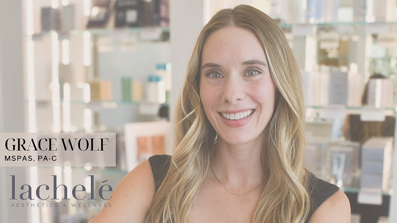 Smiling woman in a medical aesthetics setting.