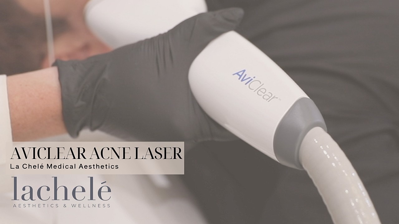 Person welcoming visitors at aesthetic clinic entrance.