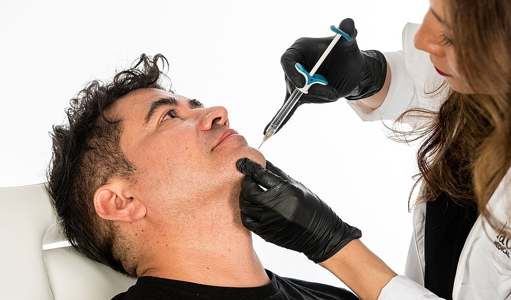 Smiling man in a suit, relaxed and happy.