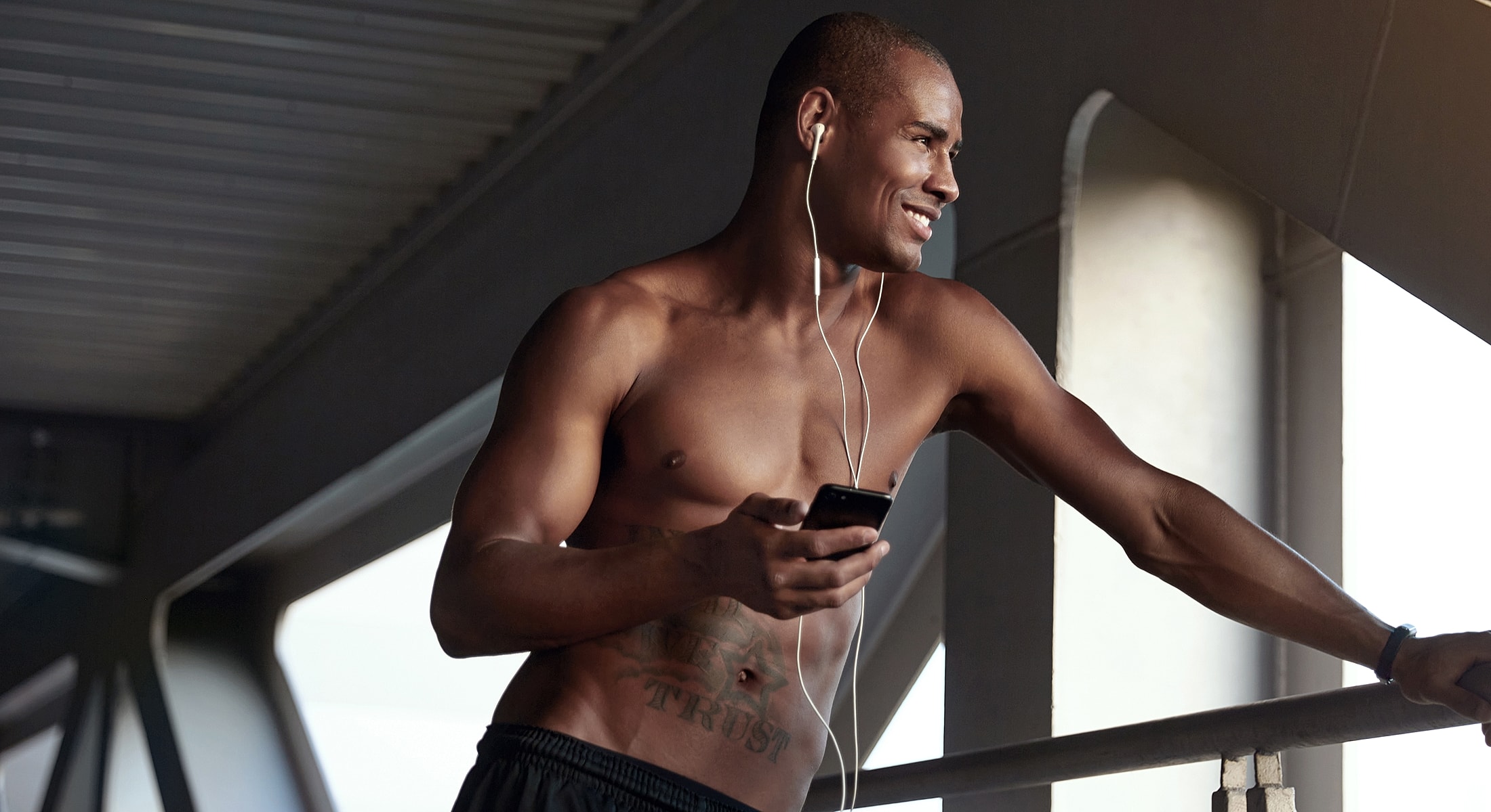 Man adjusting cuffs of striped shirt.