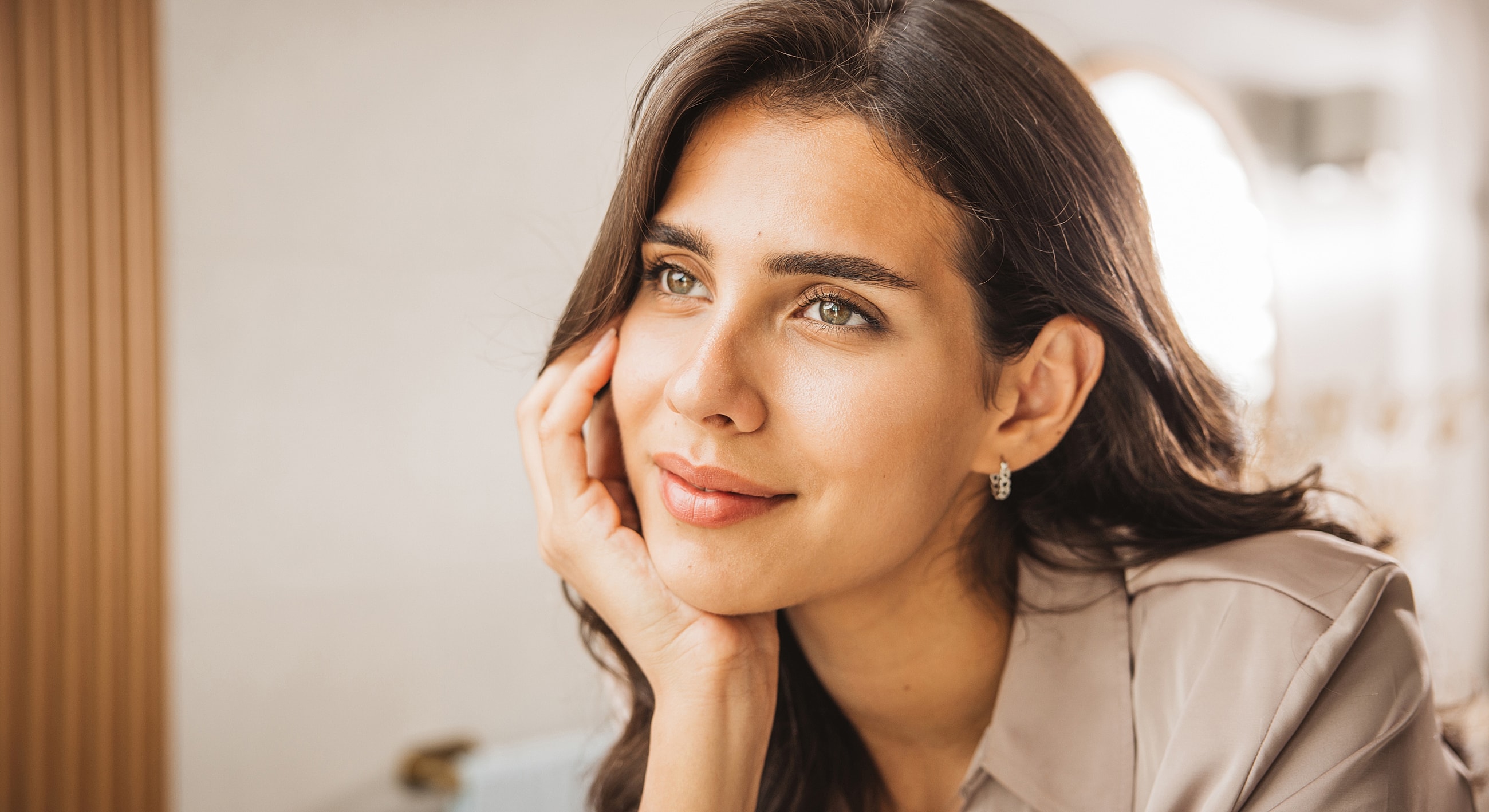 Thoughtful woman with long hair and light makeup