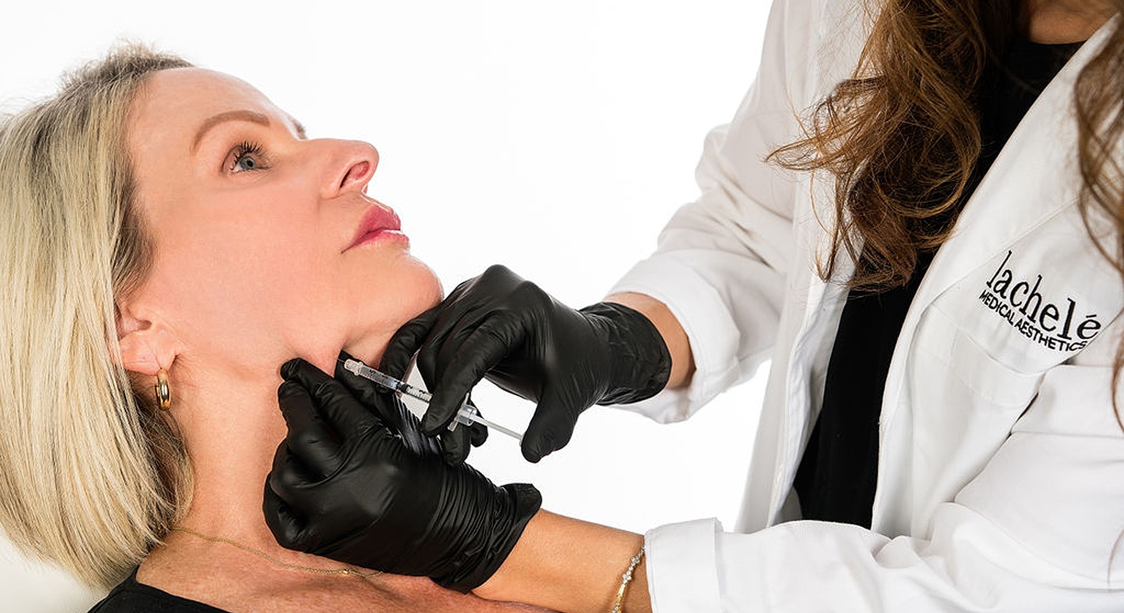 Patient receiving aesthetic treatment with needle.