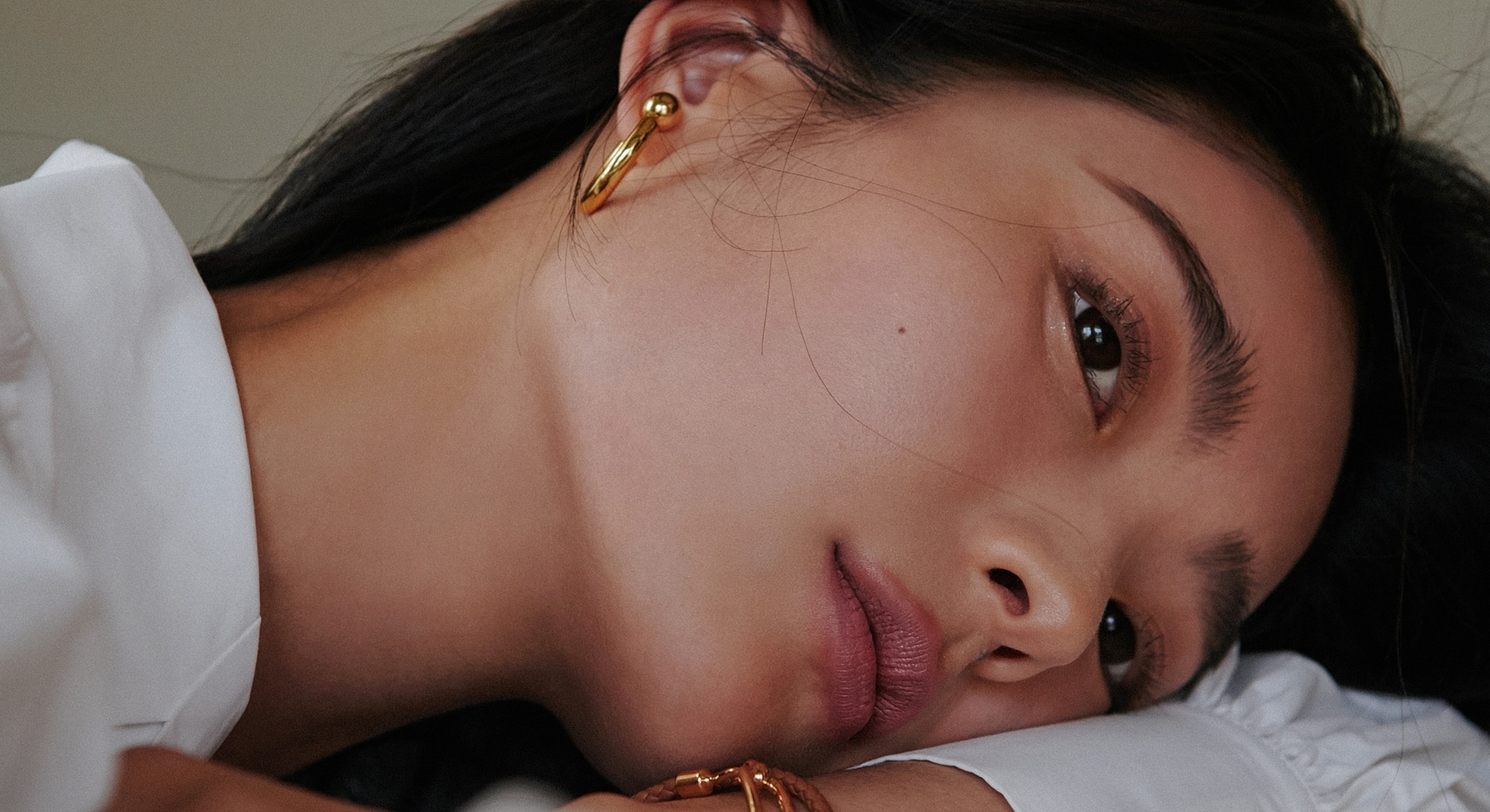 Close-up portrait of a woman with earrings.