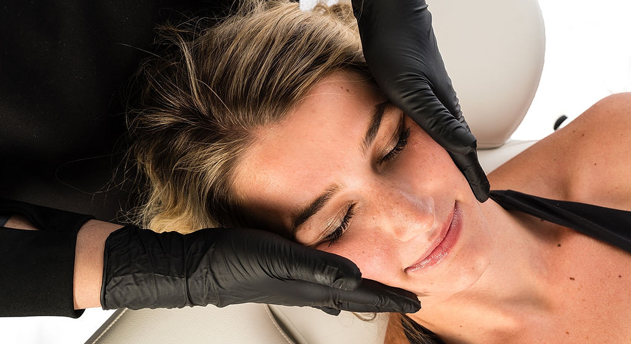Facial treatment session with professional hands.