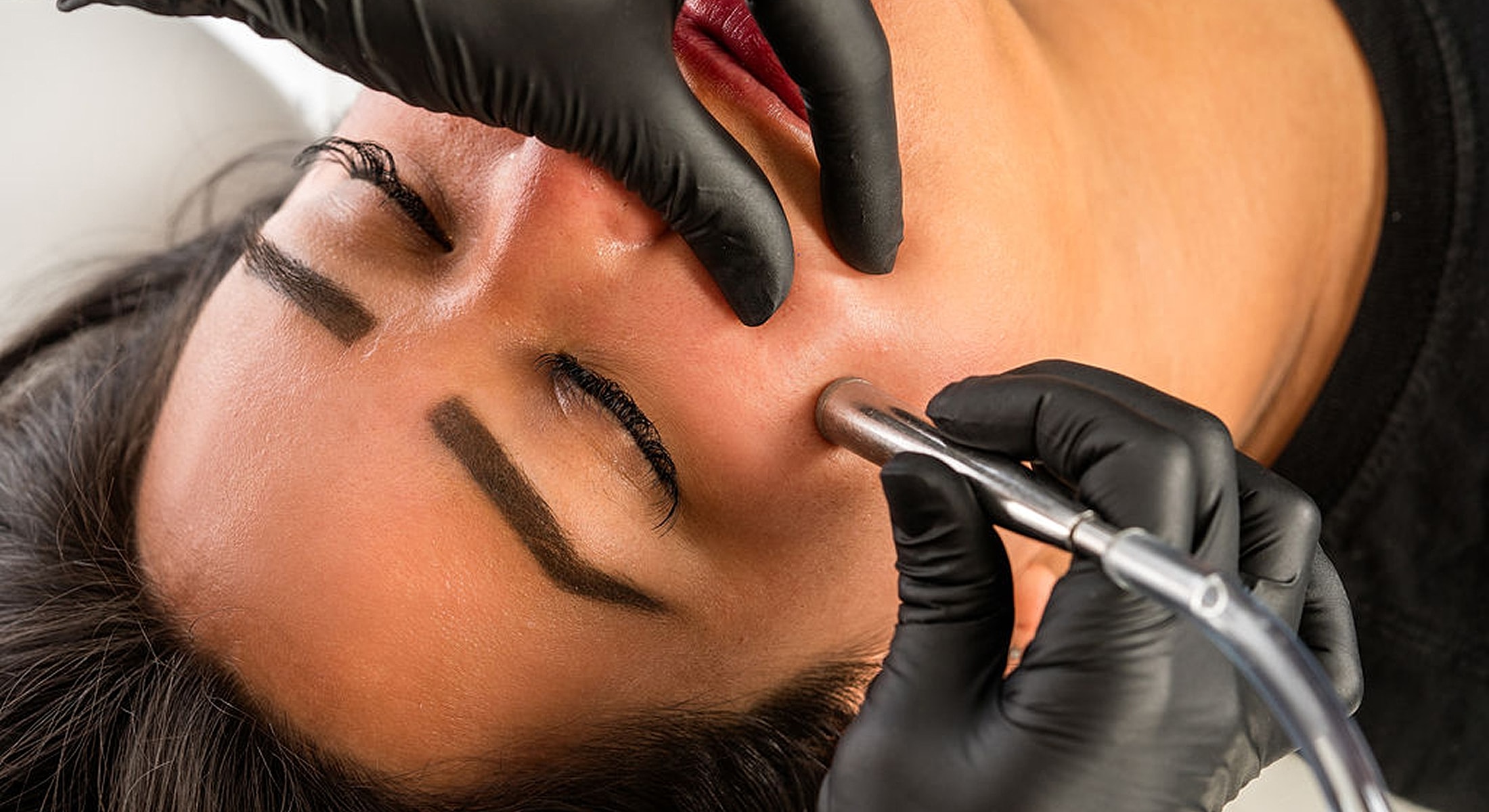 Facial treatment with a beauty tool in use.