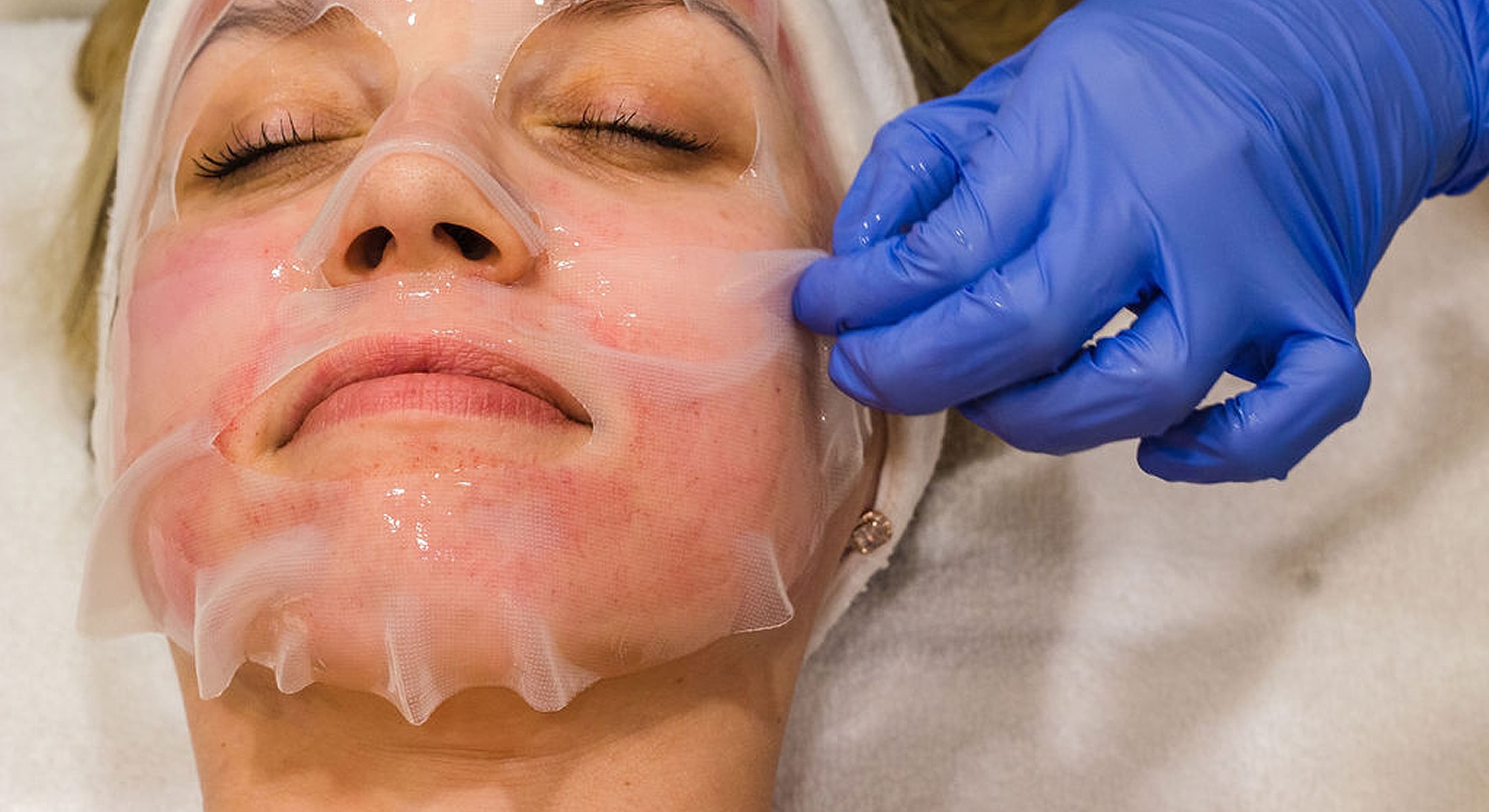 Facial treatment with gel mask application.